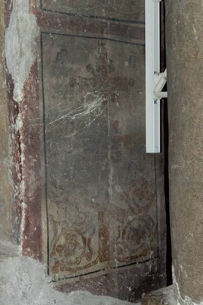 Flowered cross with a cryptogram in the bifore window