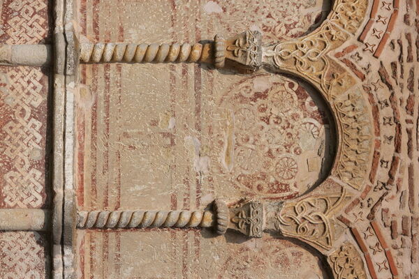 Painted rosettes under the blind arcade of the altar apse