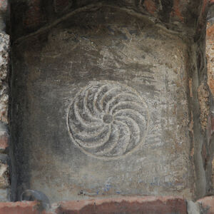 Carved rosette in niche above the portal